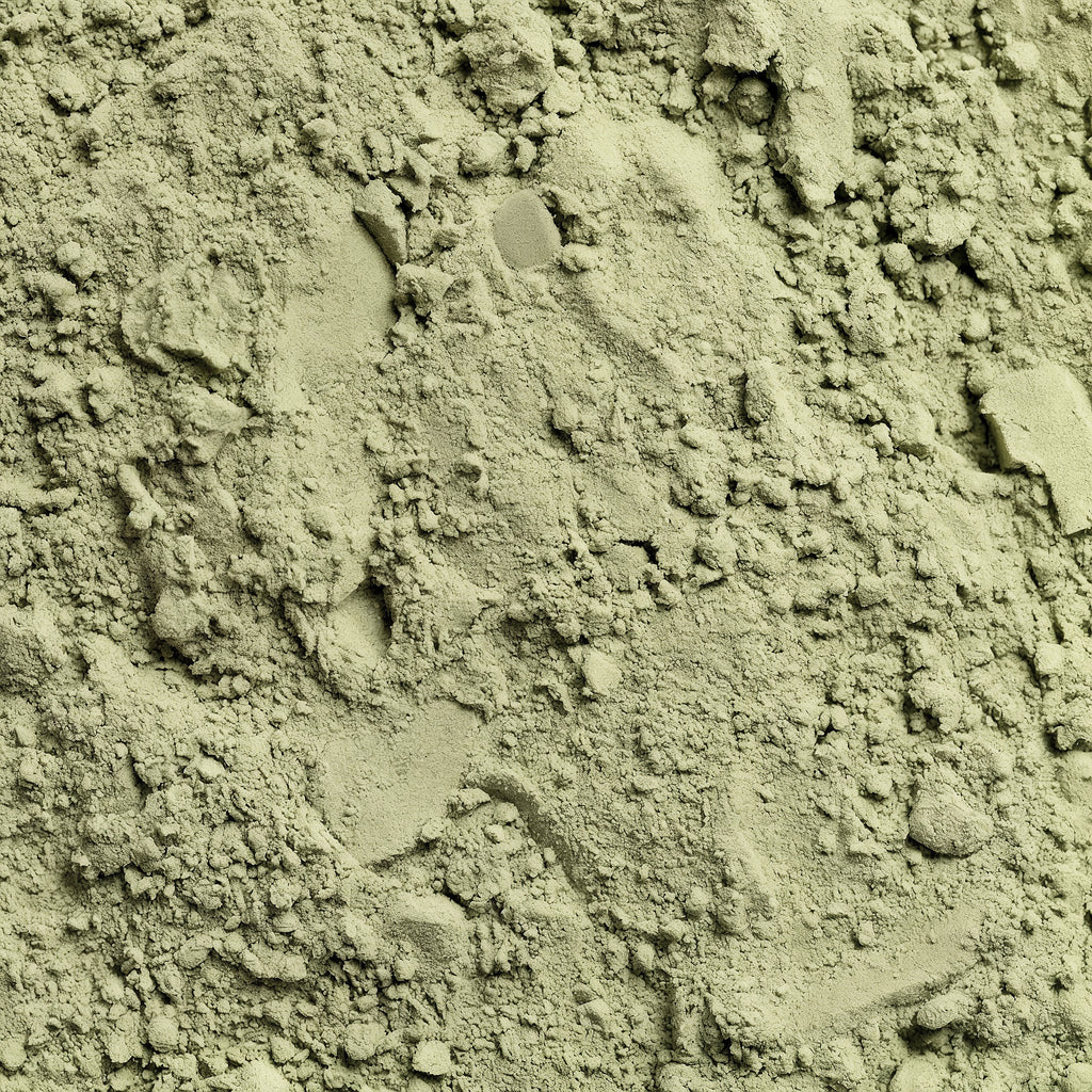 Close-up of greenish-brown powder with small clumps