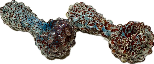 Two Ripkitty 5" blue spike spoon pipes side by side — teal-blue and dark red frit with raised bubble spike texture, front-facing view showing bowl ends and full nodule-covered bodies, white background